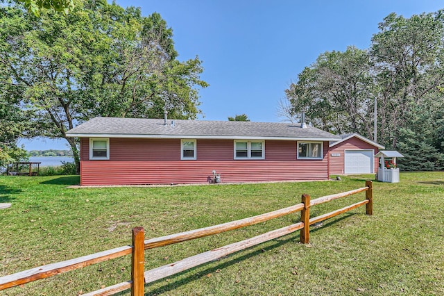 view of home's exterior with a detached garage and a yard