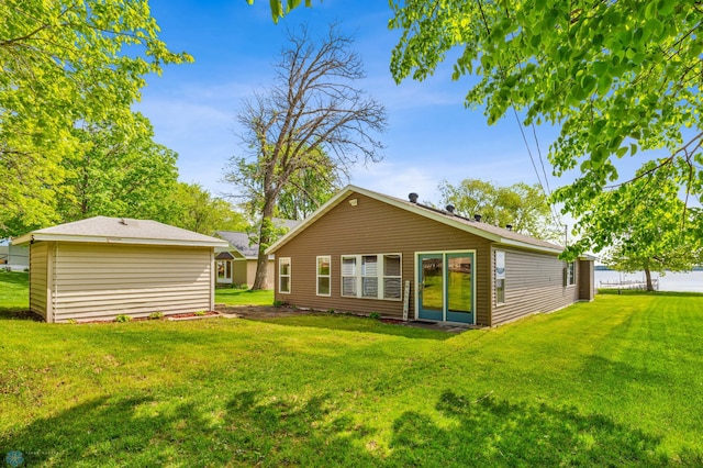 rear view of house featuring a yard