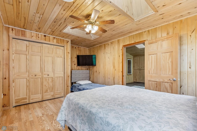 bedroom featuring wooden ceiling, wooden walls, and wood finished floors