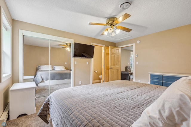 carpeted bedroom with a textured ceiling, multiple windows, a closet, and ceiling fan