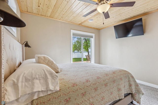 bedroom featuring baseboards, wood ceiling, access to exterior, crown molding, and carpet floors