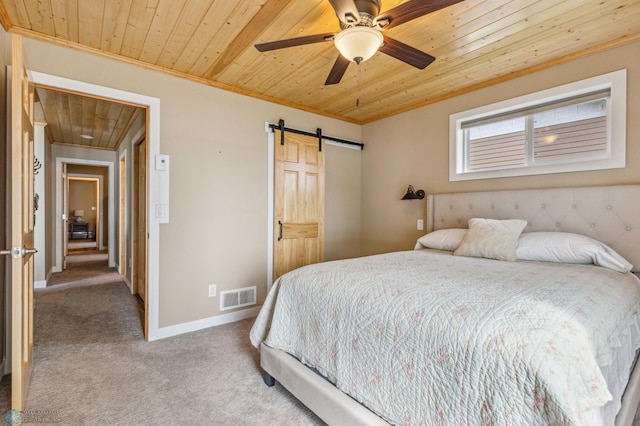 carpeted bedroom featuring a barn door, wooden ceiling, visible vents, baseboards, and ornamental molding