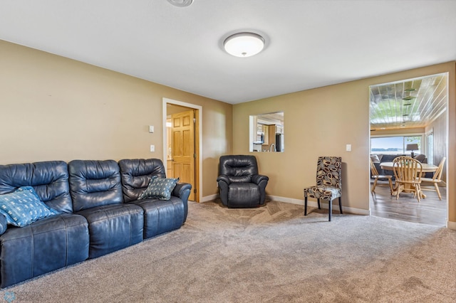 carpeted living room with baseboards