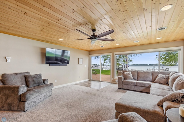 carpeted living room featuring a healthy amount of sunlight, wooden ceiling, baseboards, and recessed lighting