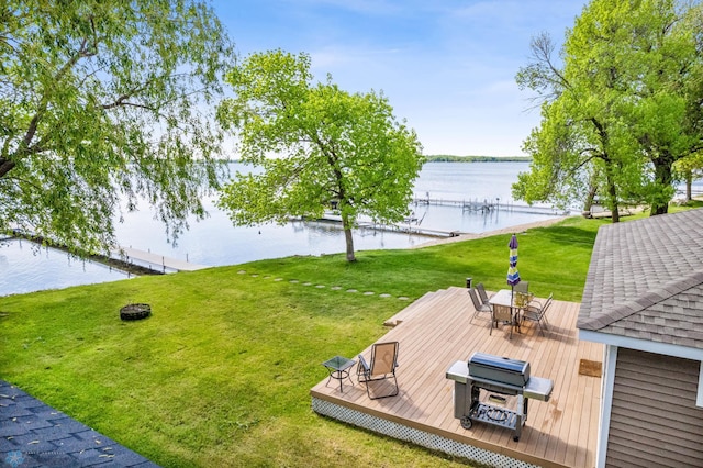 view of yard with a deck with water view and outdoor dining space