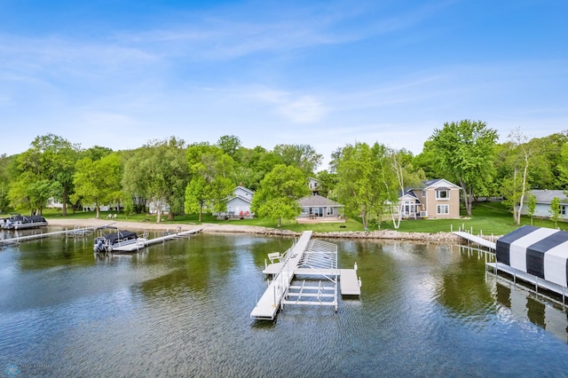 dock area with a yard and a water view