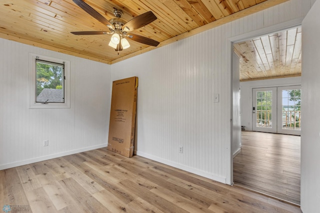 unfurnished room with french doors, a ceiling fan, wood ceiling, wood finished floors, and baseboards