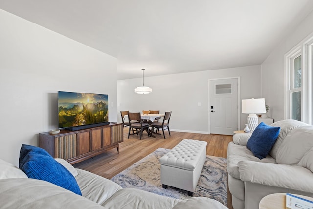 living room with baseboards and wood finished floors