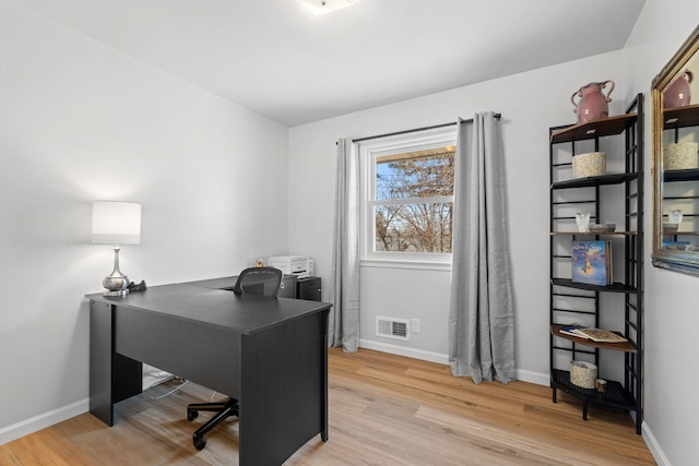 office area featuring wood finished floors, visible vents, and baseboards