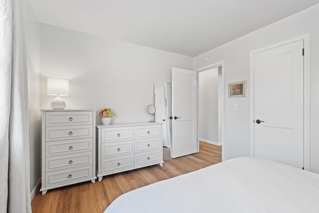 bedroom with baseboards and light wood-style floors