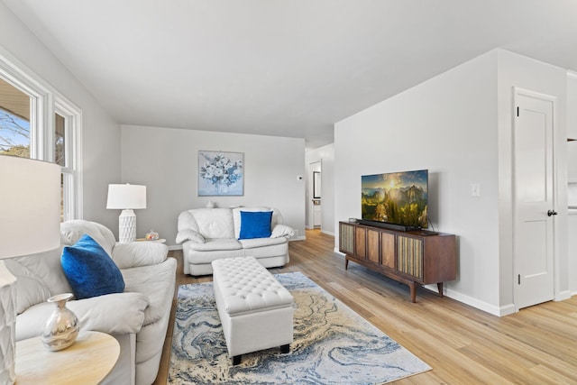 living room featuring light wood-style flooring and baseboards