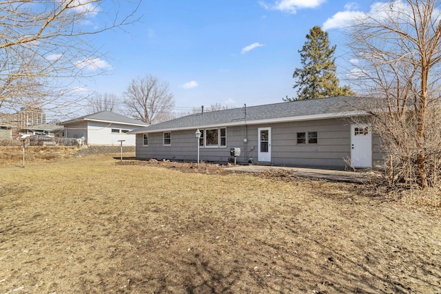 back of house with a lawn