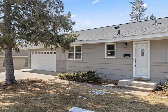 single story home featuring a garage, driveway, and a shingled roof