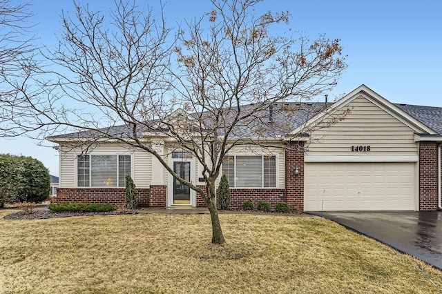 ranch-style house with an attached garage, driveway, a front lawn, and brick siding