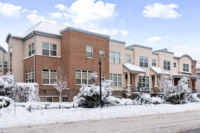 view of front of home with brick siding and stucco siding