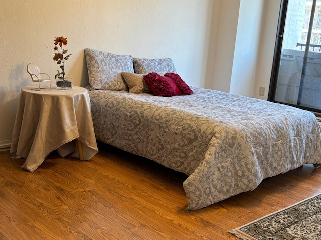 bedroom featuring wood finished floors