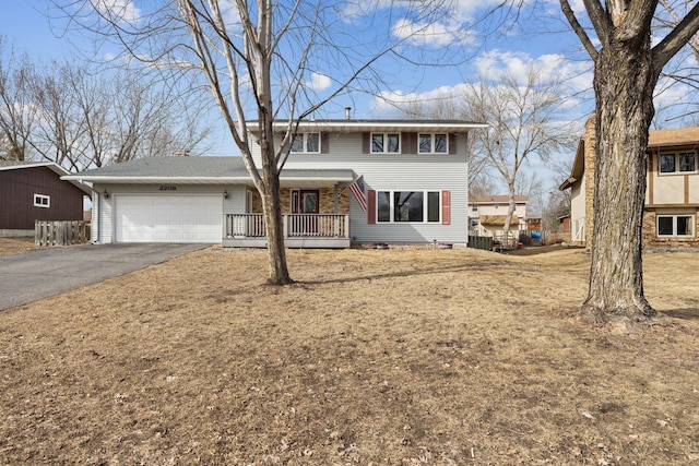 traditional-style house with a garage and driveway