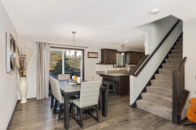 dining space with stairway, wood finished floors, and baseboards