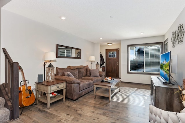 living room with recessed lighting, baseboards, and wood finished floors