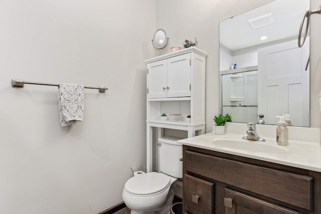 full bath with a stall shower, vanity, and toilet