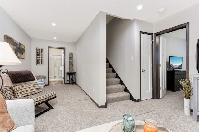 living area featuring stairs, recessed lighting, baseboards, and light colored carpet