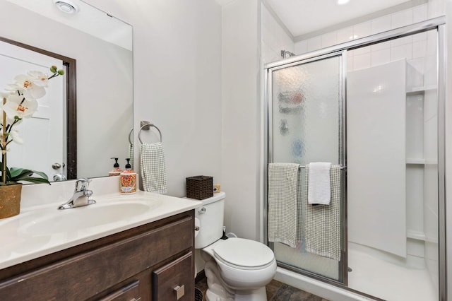 full bathroom with toilet, a shower stall, and vanity