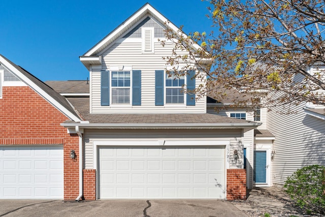 15721 France Way Unit 1312, Apple Valley, MN 55124 - view of front facade with an attached garage, brick siding, driveway, and roof with shingles