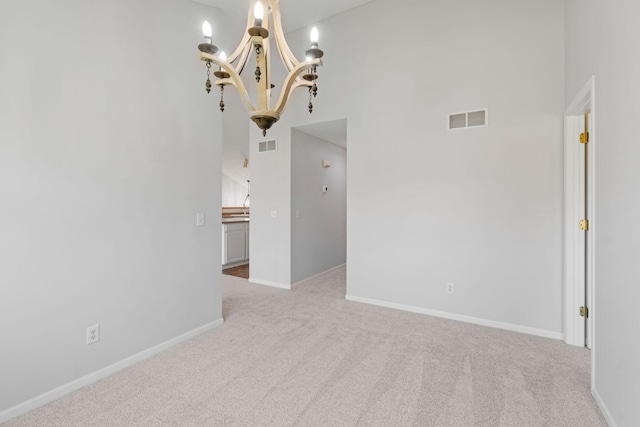 15721 France Way Unit 1312, Apple Valley, MN 55124 - carpeted spare room featuring a chandelier, a towering ceiling, baseboards, and visible vents
