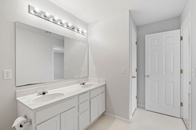 15721 France Way Unit 1312, Apple Valley, MN 55124 - full bathroom featuring baseboards, a textured ceiling, double vanity, and a sink