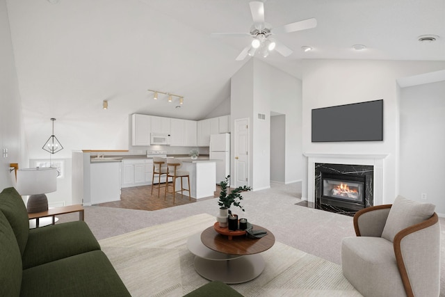 15721 France Way Unit 1312, Apple Valley, MN 55124 - living area with high vaulted ceiling, a premium fireplace, baseboards, ceiling fan, and light colored carpet
