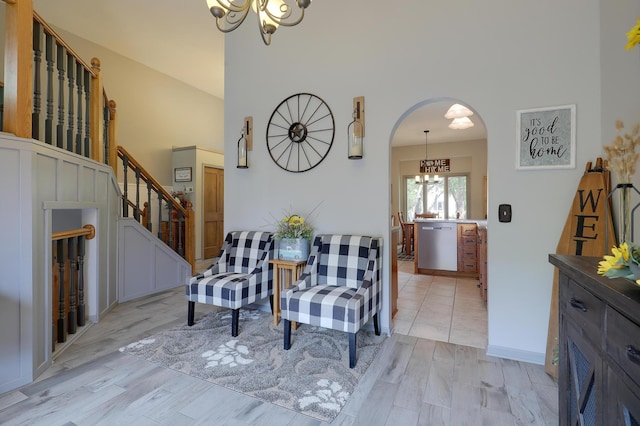 11259 71st Ave N, Maple Grove, MN 55369 - sitting room featuring a chandelier, stairway, light wood finished floors, arched walkways, and baseboards