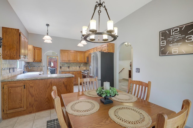 11259 71st Ave N, Maple Grove, MN 55369 - dining space with arched walkways, a chandelier, and light tile patterned floors