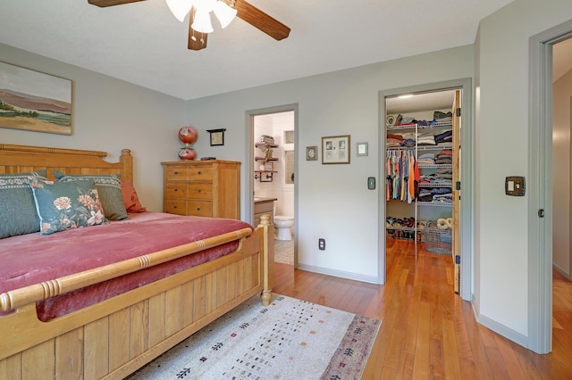 11259 71st Ave N, Maple Grove, MN 55369 - bedroom with a walk in closet, light wood-style flooring, a closet, baseboards, and ensuite bath