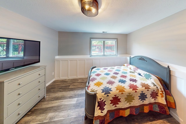 11259 71st Ave N, Maple Grove, MN 55369 - bedroom with wood finished floors and a textured ceiling