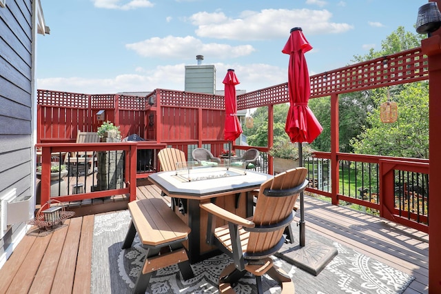11259 71st Ave N, Maple Grove, MN 55369 - wooden deck featuring outdoor dining space and an outdoor fire pit