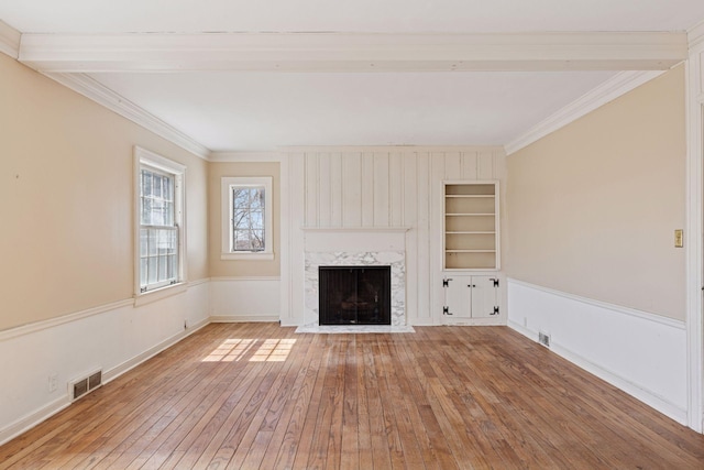 2148 Delaware Ave, Sunfish Lake, MN 55118 - unfurnished living room featuring hardwood / wood-style flooring, built in features, a premium fireplace, crown molding, and baseboards