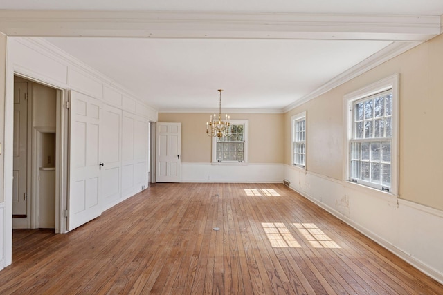 2148 Delaware Ave, Sunfish Lake, MN 55118 - unfurnished dining area with a chandelier, light wood finished floors, crown molding, and baseboards