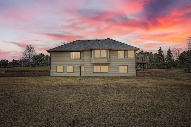 13847 Taconite St NE, Ham Lake, MN 55304 - back of property at dusk featuring a yard and a shingled roof