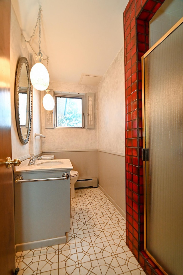 full bathroom featuring vanity, a shower with door, toilet, and baseboard heating