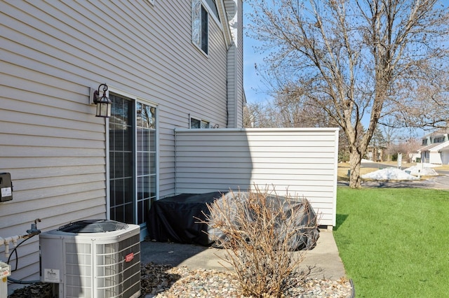 view of home's exterior featuring a yard and central AC