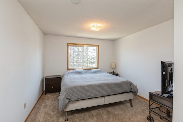 bedroom featuring baseboards and carpet floors