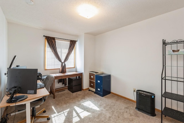 home office featuring carpet flooring, a textured ceiling, and baseboards