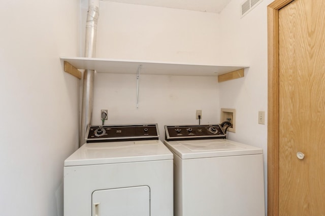 laundry room featuring laundry area, visible vents, and washing machine and clothes dryer