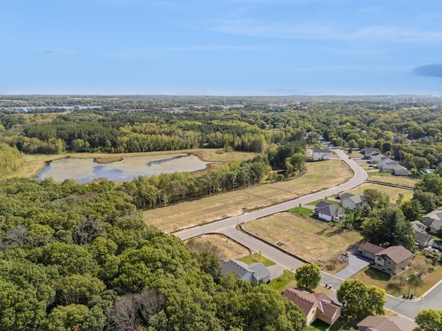 aerial view featuring a water view and a view of trees