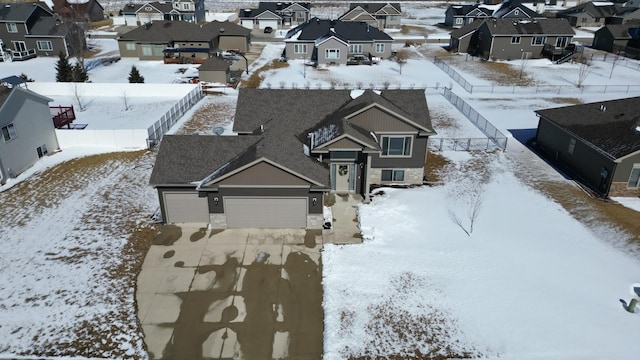 snowy aerial view with a residential view