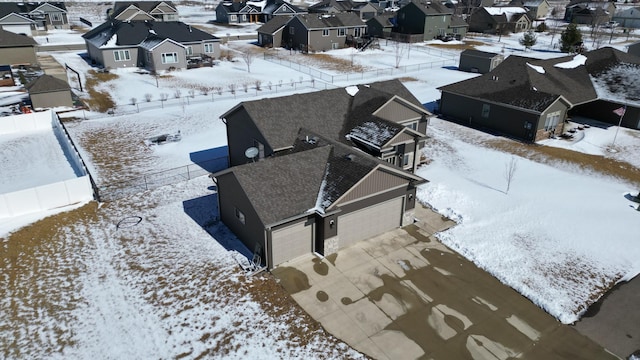 snowy aerial view with a residential view