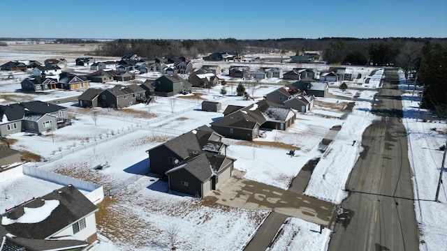 snowy aerial view featuring a residential view