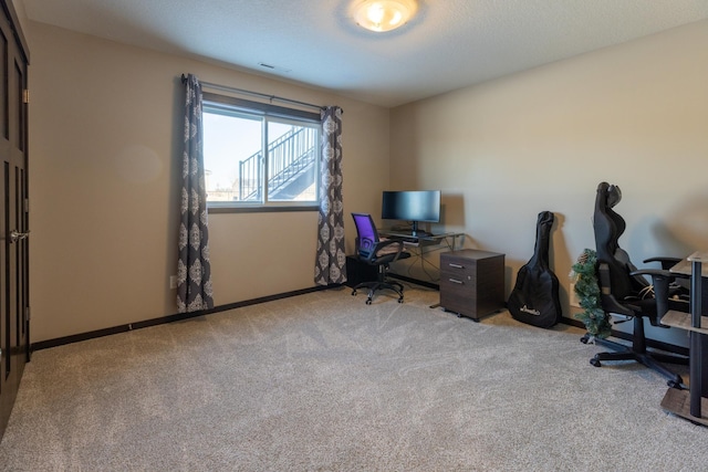 carpeted office featuring baseboards and visible vents