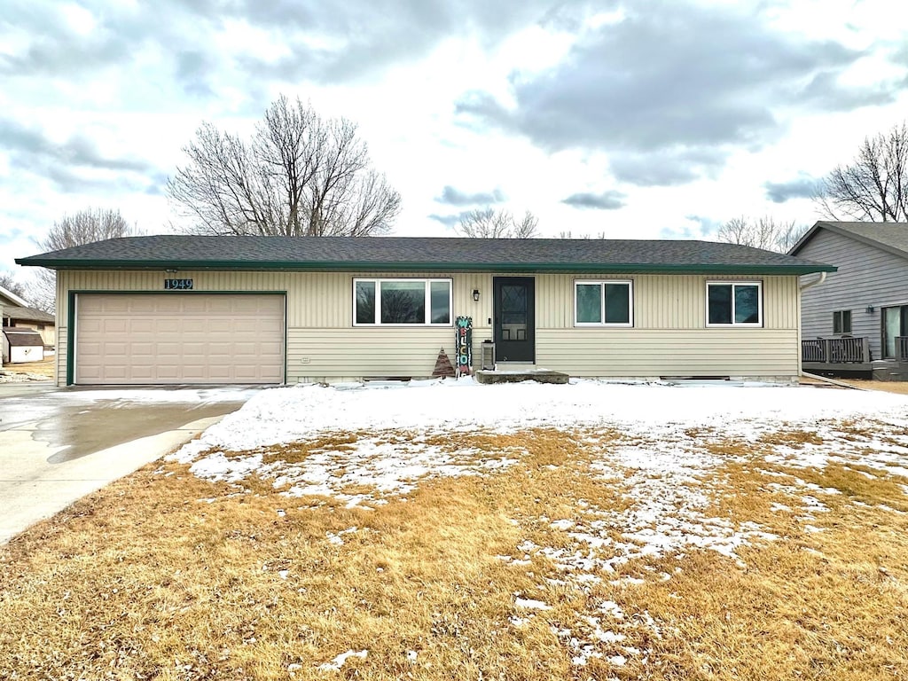 ranch-style home with a garage and driveway