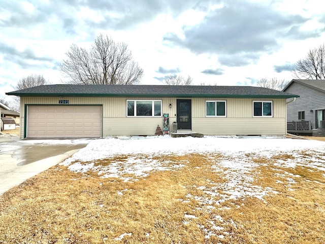 ranch-style home with a garage and driveway